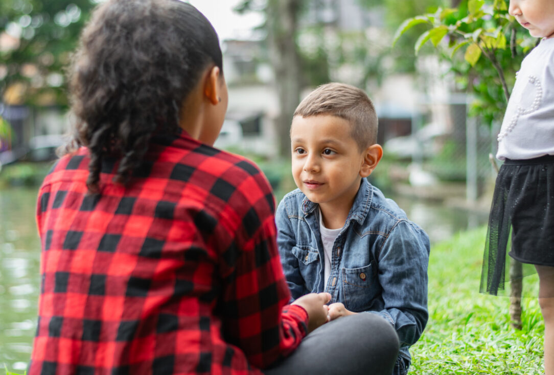 Children facing each other talking in a natural park Child Grief Counseling in Scottsdale, AZ | Pathways Counseling Services