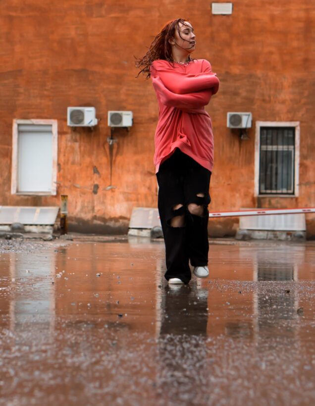 Pathways Counseling Services DBT Therapy scottsdale az Young woman standing in the rain with arms crossed, expressing emotional resilience and distress tolerance as taught in DBT therapy at Pathways counseling services in scottsdale az