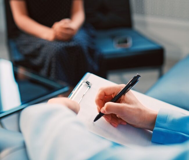 Cognitive Behavioral Therapy in Scottsdale AZ | Pathways Counseling Services cognitive behavioral therapy session in Scottsdale AZ with therapist writing notes and guiding client through thought patterns at Pathways Counseling Services