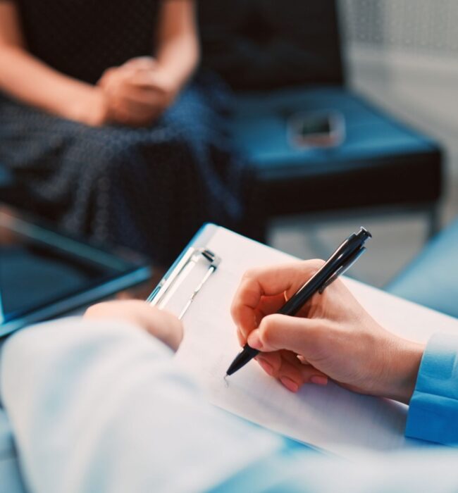 cognitive behavioral therapy session in Scottsdale AZ with therapist writing notes and guiding client through thought patterns at Pathways Counseling Services
