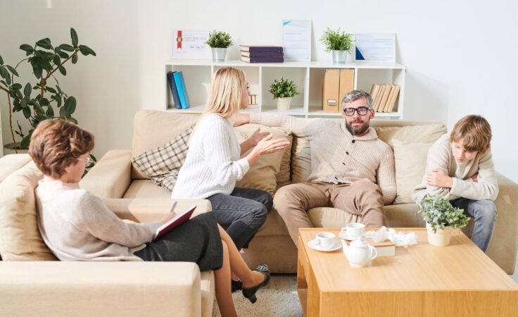 family therapist in Scottsdale AZ helping parents and child improve communication during counseling session at Pathways Counseling Services
