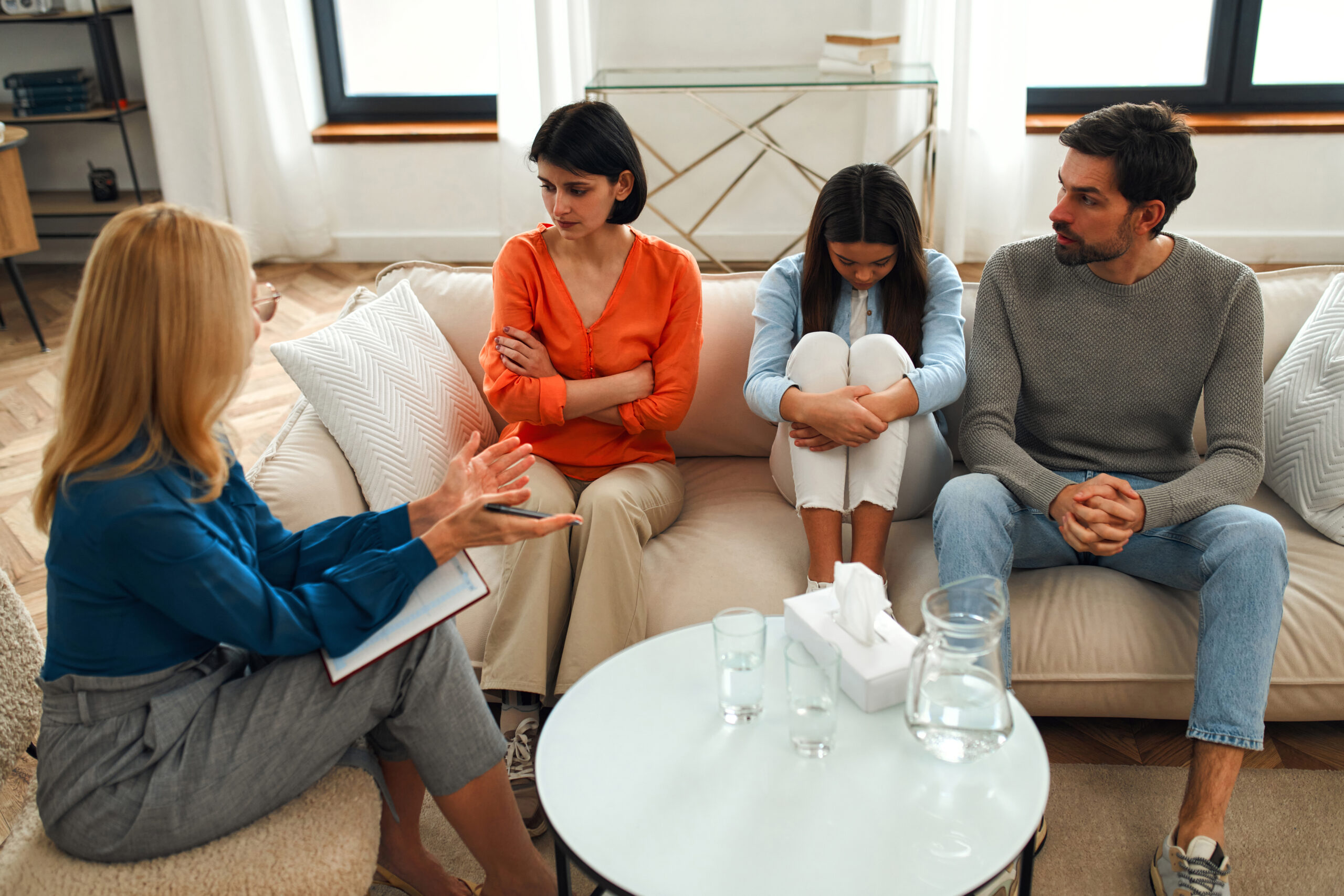 family therapist in Scottsdale AZ helping parents and child improve communication during counseling session at Pathways Counseling Services