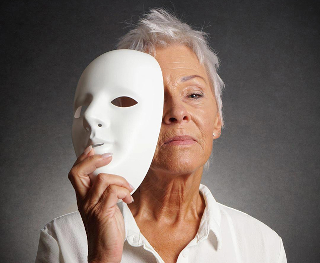 Woman holding a white mask near her face