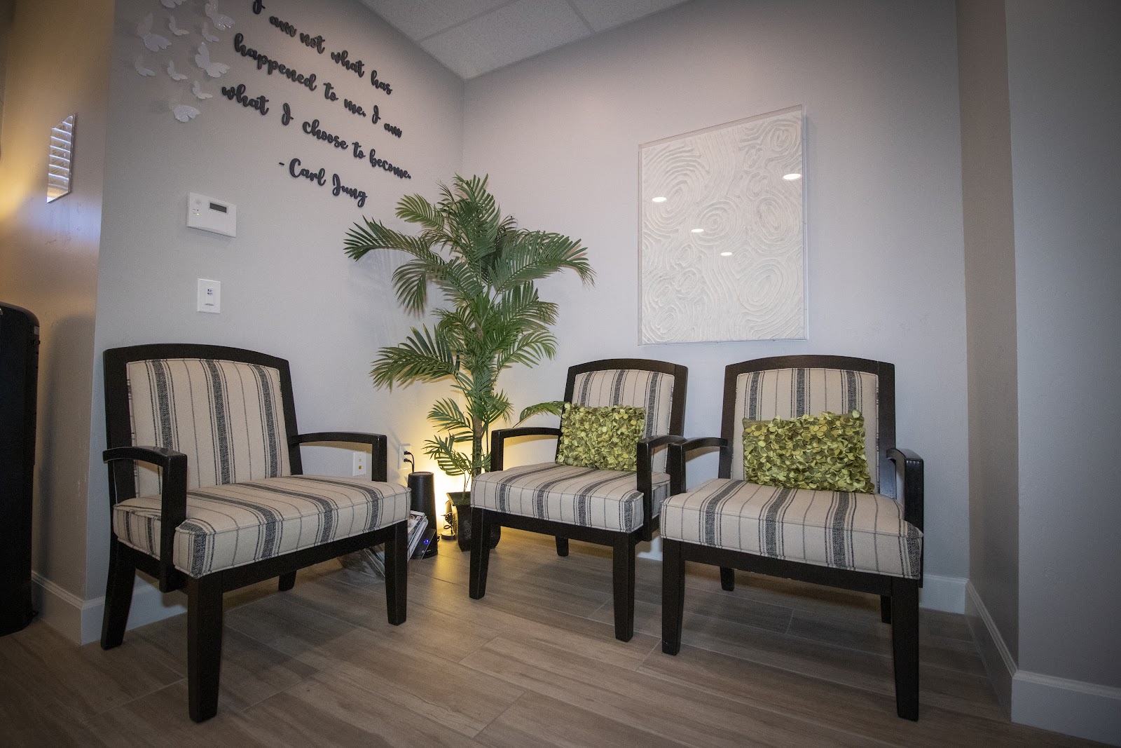 Waiting room chairs and a palm at the Pathways office