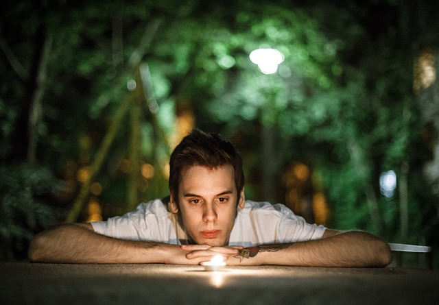 Cognitive Behavioral Therapy - Young Man in White Shirt Watching a Candle Flicker