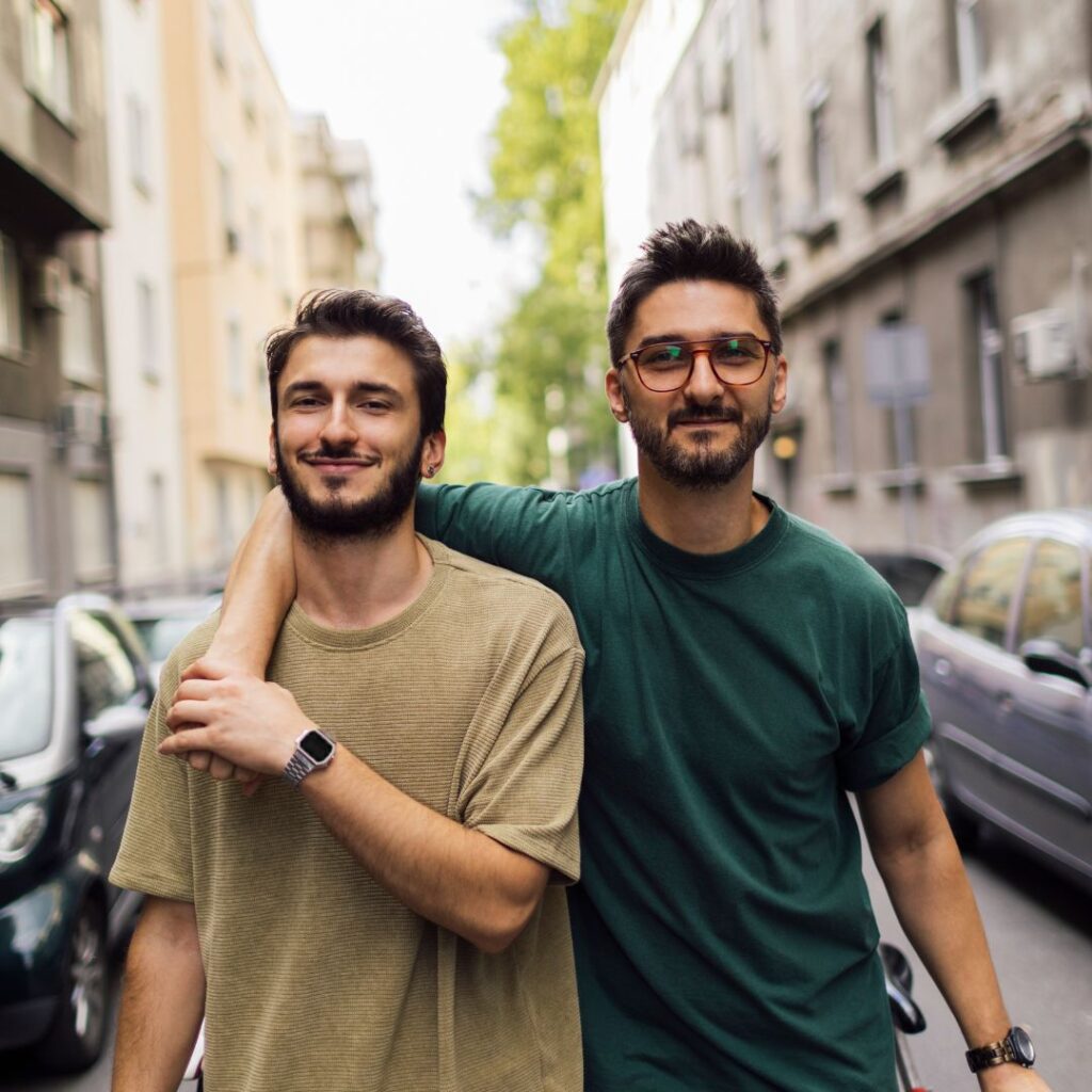 LGBTQIA+ couple walking down street